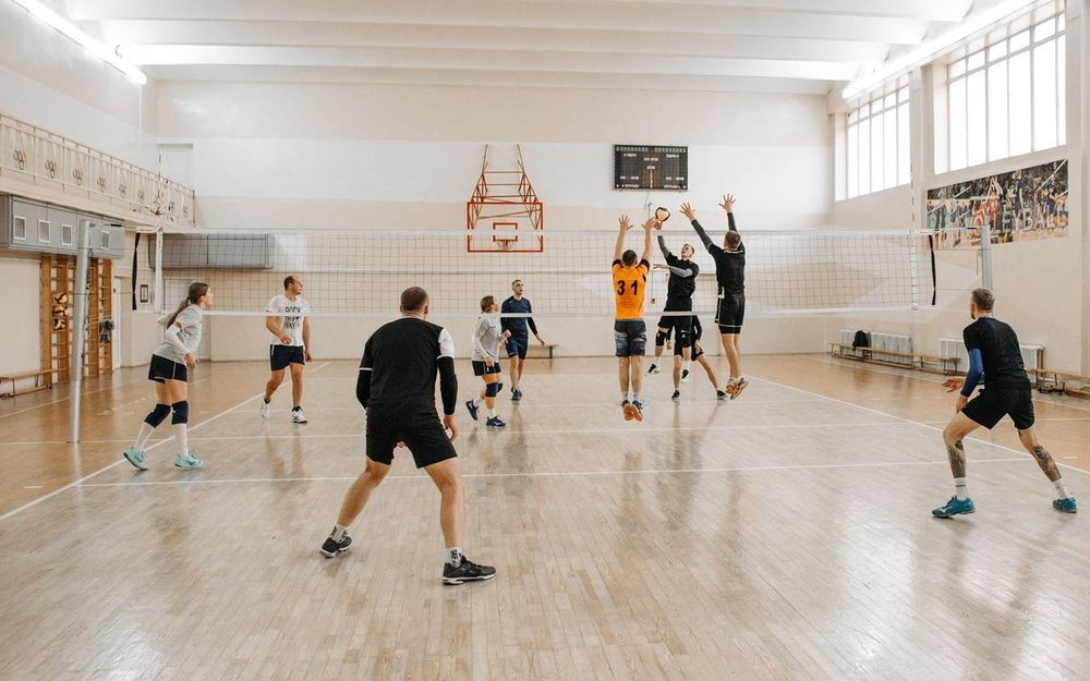 A volleyball match with a LIVE badge and a score bar added to the photo, as an example of how your stream can look.